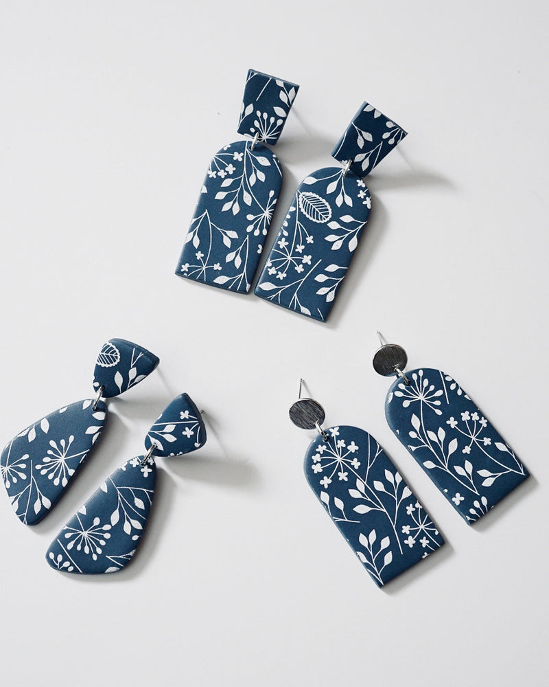 Handmade Blue & White Floral Print Polymer Clay Statement Earrings. Modern and cute denim blue clay dangles with detailed white floral print. Available with hypoallergenic titanium posts or clip-on option.
