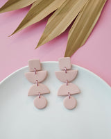 Handmade Pale Pink Polymer Clay Statement Earrings. These modern and geometric clay dangles bring movement and style to your day or evening. Hypoallergenic titanium posts or stainless steel clip-on.