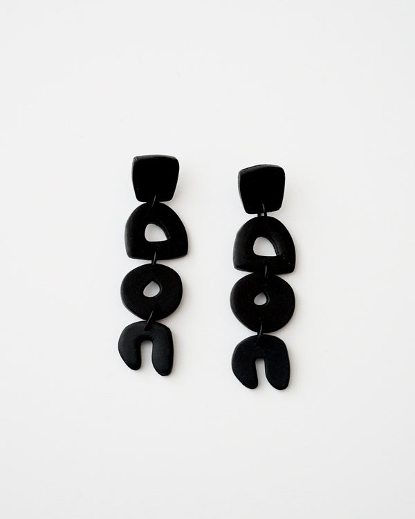 Handmade Abstract Black Polymer Clay Statement Earrings with Titanium Posts.  Dainty but unique, these clay dangles feature abstract shapes in a minimal design. Undoubtedly stylish and lightweight to wear all day, everyday. Available with hypoallergenic titanium earring posts.