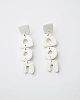 Handmade Abstract White Polymer Clay Statement Earrings with Titanium Posts.  Dainty but unique, these clay dangles feature abstract shapes in a minimal design. Undoubtedly stylish and lightweight to wear all day, everyday. Hypoallergenic titanium earring posts.