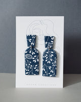 Handmade Blue & White Floral Print Polymer Clay Statement Earrings.  Modern and cute denim blue clay dangles with detailed white floral print. Available with hypoallergenic titanium posts or clip-on option. 