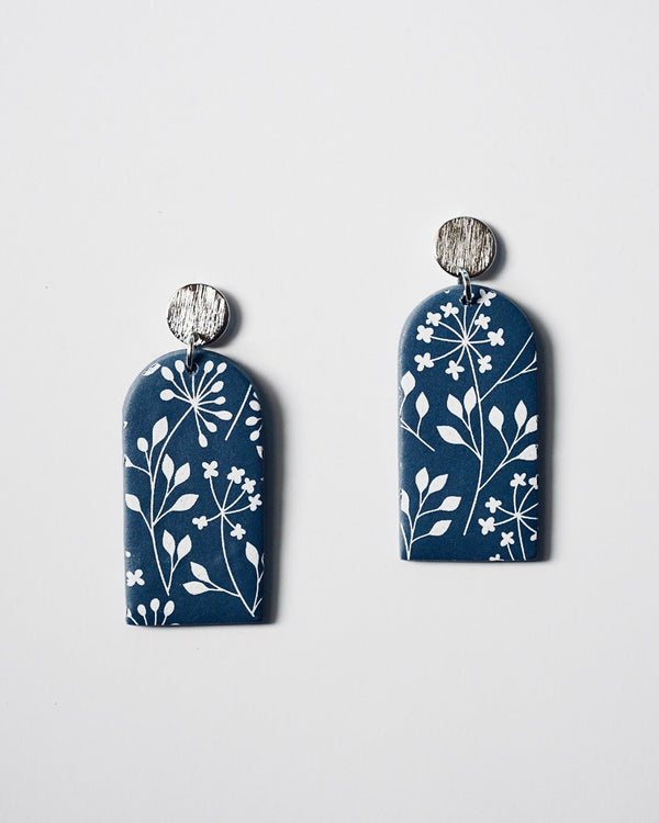 Handmade Blue & White Floral Print Polymer Clay Statement Earrings.  Modern and cute denim blue clay dangles with detailed white floral print. Hypoallergenic silver textured studs. These are stylish, lightweight and will be a standout for a chic daytime look or a night out. These earrings are a part of the Botanical Polymer Clay Collection.
